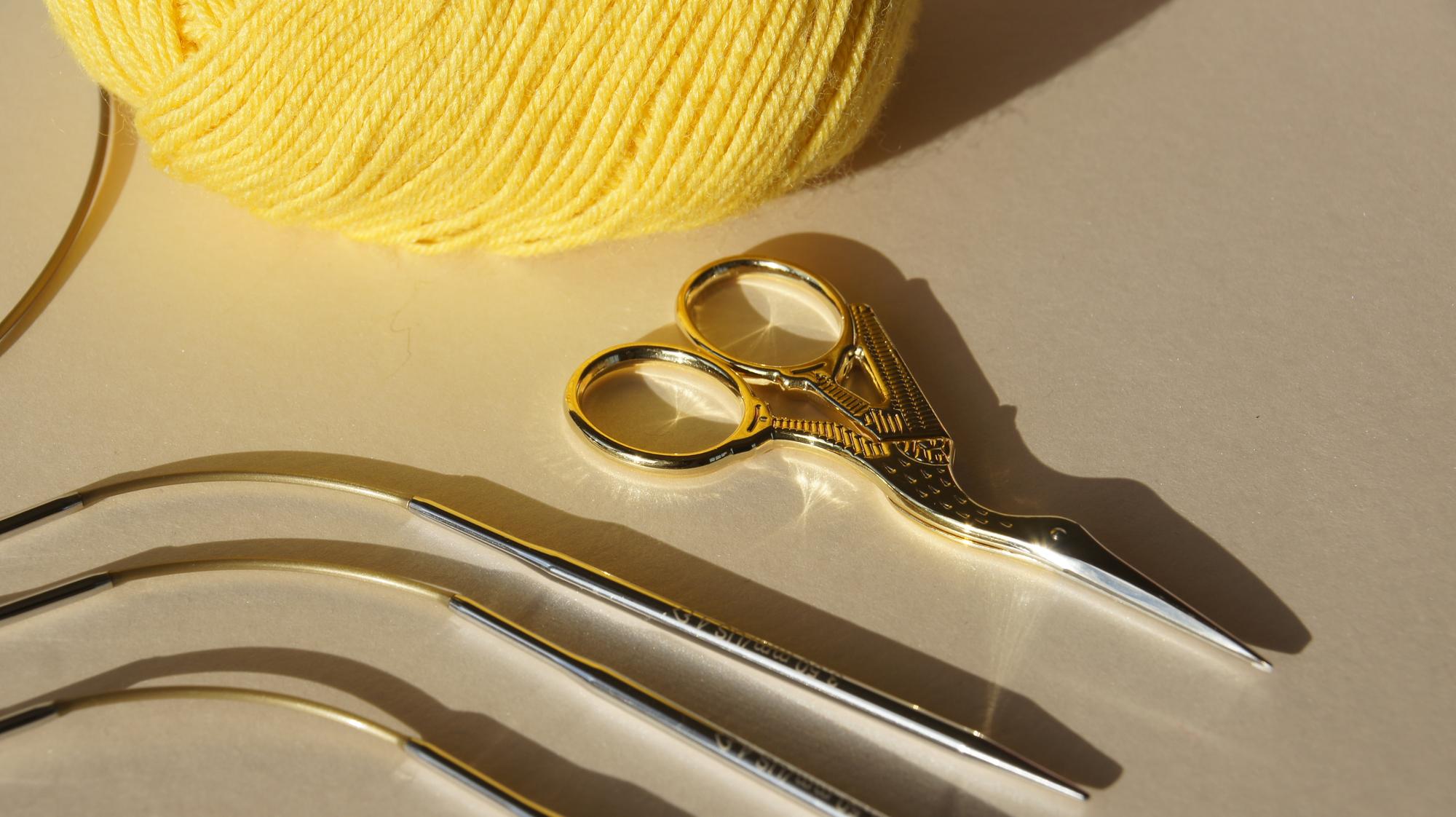 Close-up of hand embroidery on silk with gold thread